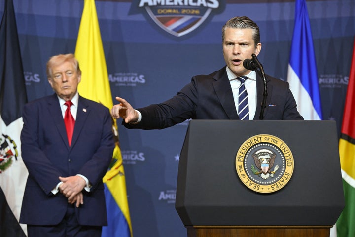 President Donald Trump looks on as Defense Secretary Pete Hegseth speaks at the Shield of the Americas summit at Trump National Doral in Miami on March 7, 2026.