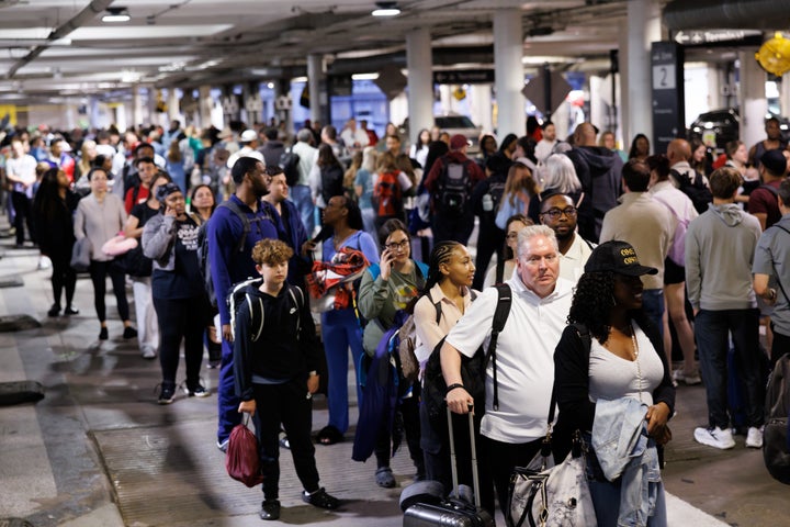 Travelers wait in line at a Transportation Security Administration (TSA) checkpoint at William P. Hobby Airport in Houston, Texas, on Monday. Airports in the U.S. are reporting longer-than-normal wait times in security lines, as TSA agents are poised to miss their first full paycheck this week. 