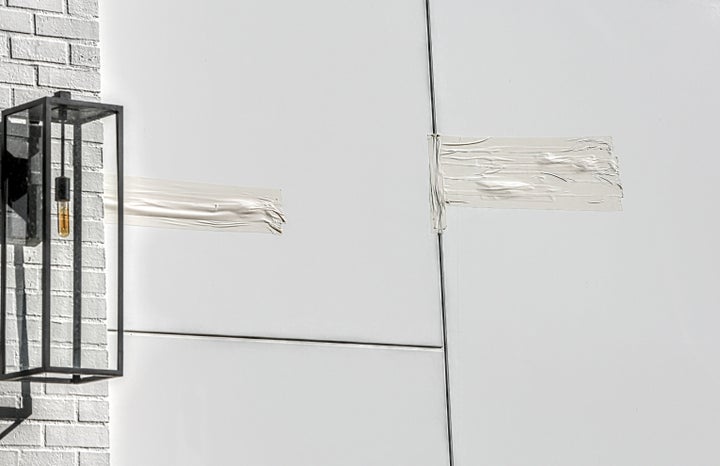 The tape covers an area allegedly hit by bullets in the driveway of Rihanna's home in Beverly Hills, California.