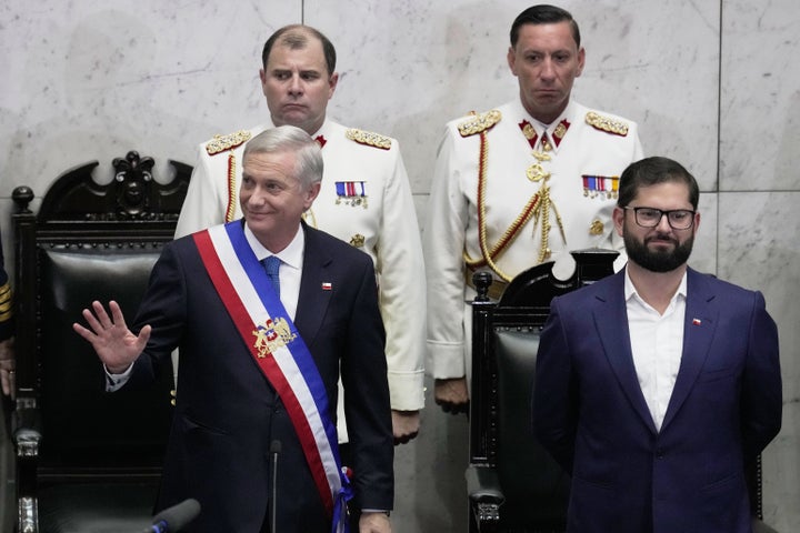 President Jose Antonio Kast, left, waves after taking the oath of office beside Chile outgoing President Gabriel Boric during his inauguration in Valparaiso, Chile, Wednesday, March 11, 2026. (AP Photo/Esteban Felix)