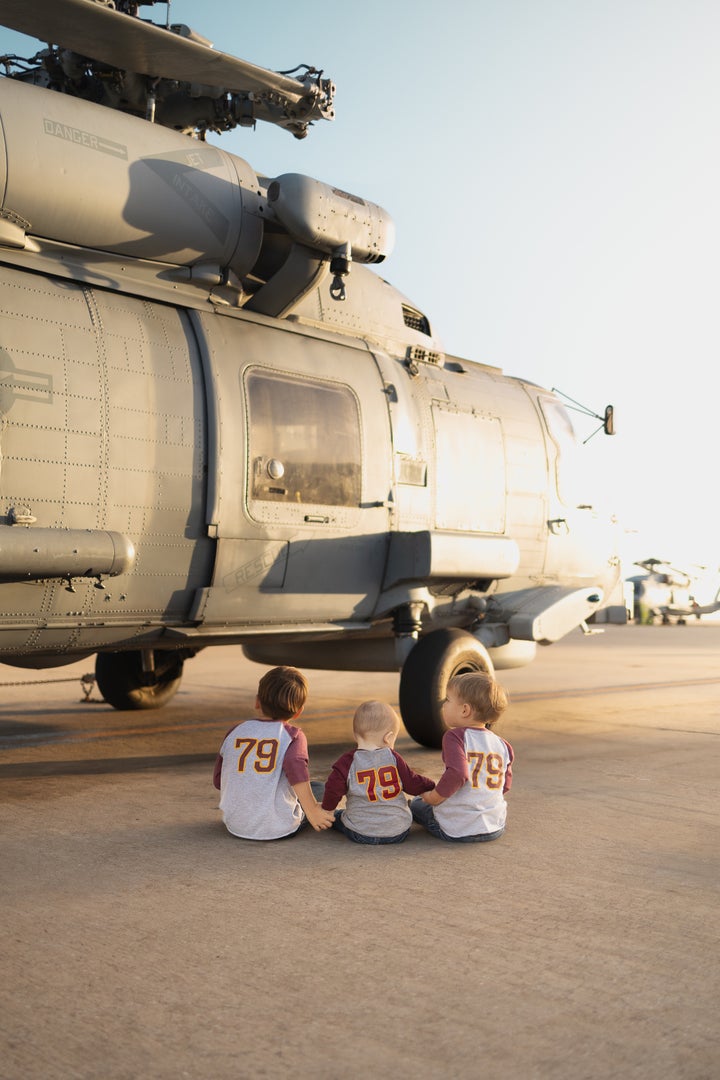 The author's three young boys with an MH-60R helicopter at Naval Station Rota.