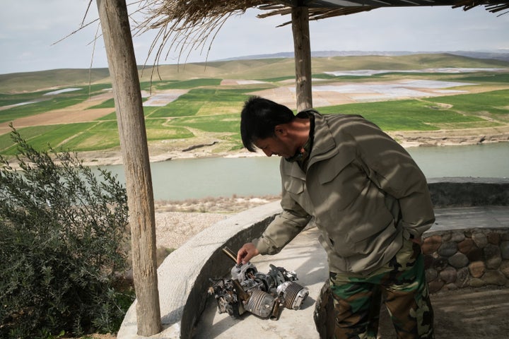 Rebaz Sharifi, a unit commander in the armed wing of the Kurdish-Iranian opposition group Kurdistan Freedom Party (PAK), checks a small engine at a military base attacked by Iranian drones last week on the outskirts of Erbil, Iraq, Wednesday, March 11, 2026. (AP Photo/Leo Correa)