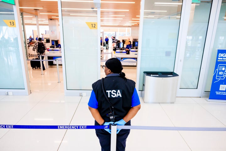 A TSA agent stands outside a security checkpoint at Denver International Airport on Nov. 8, 2025.
