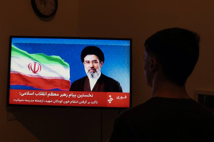 A man watches a televised statement by Iran's new supreme leader Mojtaba Khamenei on March 12, 2026. Iran's new supreme leader ordered the vital Strait of Hormuz oil shipping lane to remain closed on March 12, while President Donald Trump said stopping the Islamic republic's "evil empire" was more important than crude prices. Ayatollah Mojtaba Khamenei, who was reportedly injured in an air strike, has yet to appear publicly since his nomination as supreme leader, and his defiant message was read by a newscaster on state television.