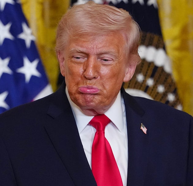 President Donald Trump reacts after Olympic bobsledder Kaillie Humphries presented him with the Order of Ikkos medal at a women's history month event in the East Room at the White House, Thursday, March 12, 2026, in Washington. (AP Photo/Julia Demaree Nikhinson)