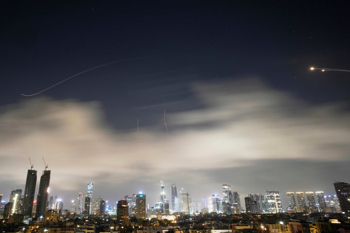 Israeli air defense system fires to intercept missiles during an Iranian attack over Tel Aviv, Israel, early Sunday, March 15, 2026. (AP Photo/Ohad Zwigenberg)