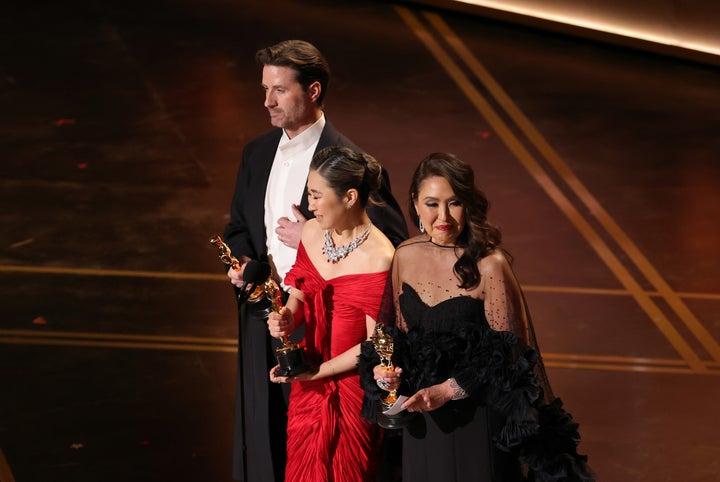 (LR) Chris Appelhans, Maggie Kang and Michelle Wong accept the animated feature film by 