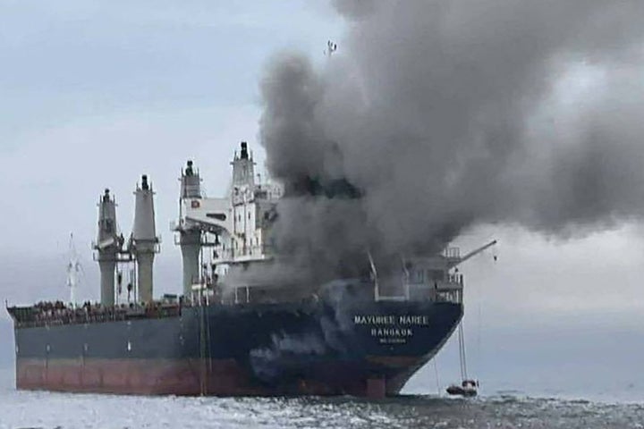 This handout photo taken on March 11, 2026, and released by the Royal Thai Navy shows smoke rising from the Thai bulk carrier 'Mayuree Naree' near the Strait of Hormuz after an attack.