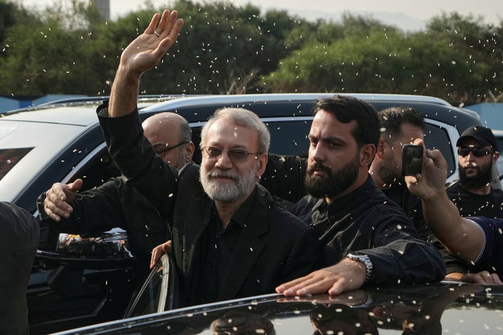 Ali Larijani, center, head of Iran's National Security Council, gestures as Hezbollah supporters throw him rice to welcome him outside the Rafik Hariri International Airport in Beirut, Lebanon, August 13, 2025.