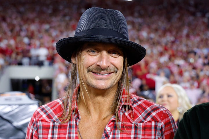 Kid Rock smiles on the sidelines during a 2024 game between the Georgia Bulldogs and the Alabama Crimson Tide at Bryant-Denny Stadium in Tuscaloosa, Alabama.