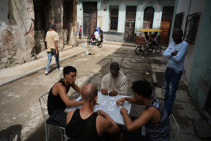 People play dominoes outside during a blackout in Havana, Tuesday, March 17, 2026. (AP Photo/Ramon Espinosa)