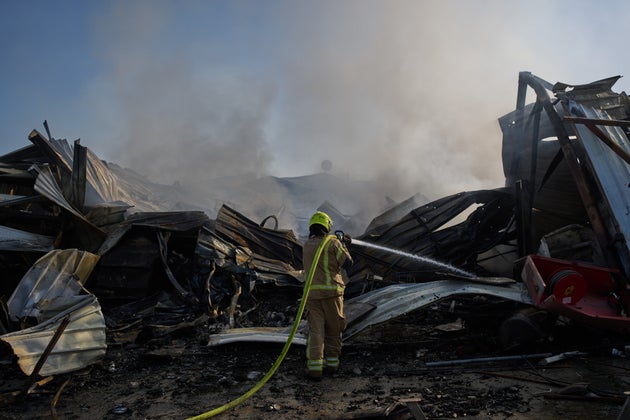 A firefighter works to extinguish a fire at the site of a direct hit from an Iranian missile in central Israel, Wednesday, March 18, 2026. (AP Photo/Oded Balilty)