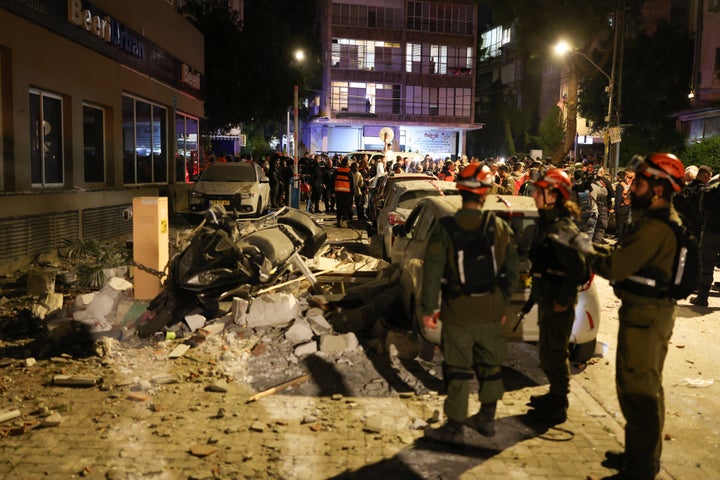 Police and first responders work at a scene where an apartment was damaged by a missile strike, in the outskirts of Tel Aviv, Israel on March 18, 2026.