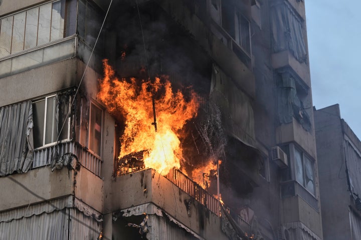 Smoke and flame rise from a residential building following an Israeli airstrike in central Beirut, Lebanon, on March 18, 2026.