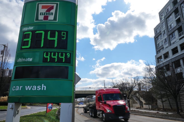 Fuel prices are displayed on a sign at a gas station as a fuel truck drives by, Tuesday, March 17, 2026, in Baltimore. (AP Photo/Stephanie Scarbrough)