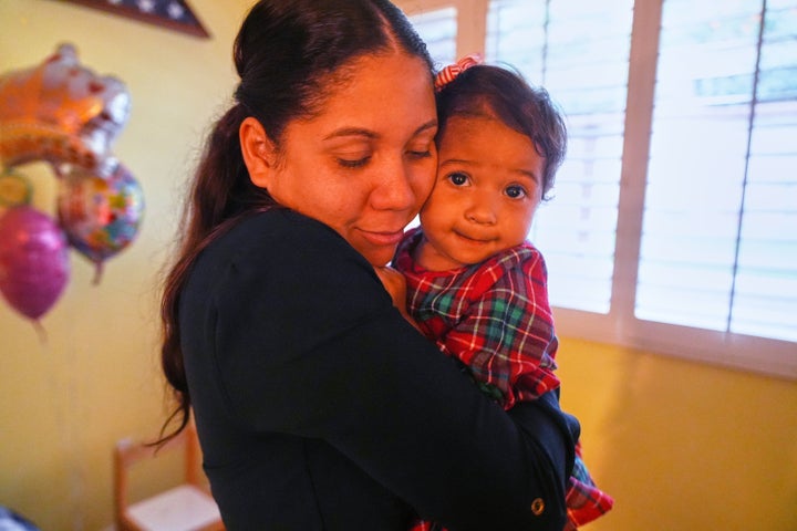 Kheilin Valero Marcano hugs her 18-month-old daughter, Amalia Arrieta Valero, in Southern California on Feb. 10, 2026. Amalia and her family were able to relocate earlier this year after she nearly died of respiratory distress during their 57-day detention period. Federal immigration officials have denied the family's claim that the staff did not provide the necessary medical treatment upon returning to the facility in Dilley, Texas, from the hospital.
