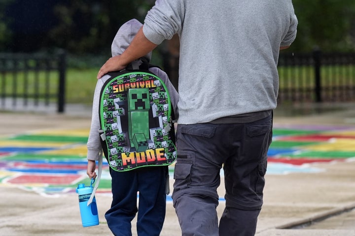 A Funston Elementary School student wears a Minecraft Survival Mode backpack as he arrives for school in Chicago's Logan Square neighborhood, on Oct. 15, 2025. The area fell into chaos just weeks earlier after federal immigration agents threw canisters of tear gas outside the school, leaving families shocked and feeling unsafe.