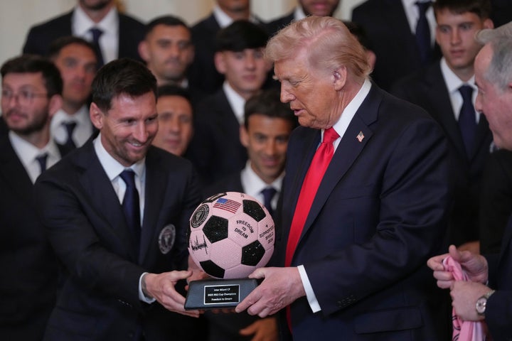 Donald Trump receives a soccer ball trophy from Lionel Messi during an event to honor the 2025 Major League Soccer champions Inter Miami at the White House in March 2026.