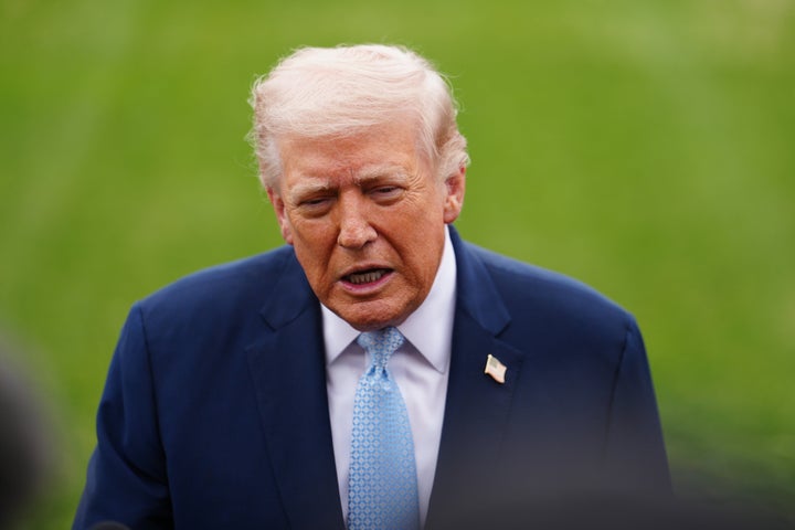President Donald Trump speaks with reporters before departing on Marine One from the South Lawn of the White House, Friday, March 20, 2026, in Washington. (AP Photo/Julia Demaree Nikhinson)