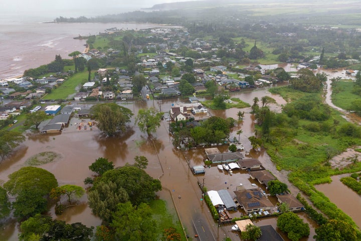 Streets are flooded from severe rains, Friday, March 20, 2026, in Haleiwa, Hawaii. (AP Photo/Mengshin Lin)