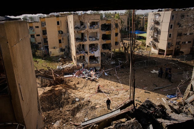People look at residential buildings damaged by an Iranian missile strike in Arad, southern Israel, Sunday, March 22, 2026. (AP Photo/Ohad Zwigenberg)