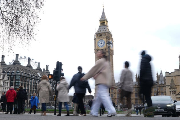 Pedastrians walk across Parliament Square in front of the Elizabeth Tower, known as Big Ben, in London, Tuesday, Feb. 10, 2026.(AP Photo/Alastair Grant)
