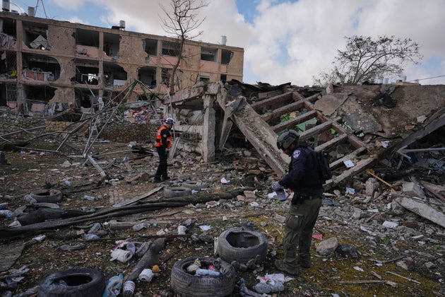 Israeli security forces survey the site that was struck by an Iranian missile in Dimona, southern Israel, on Sunday.