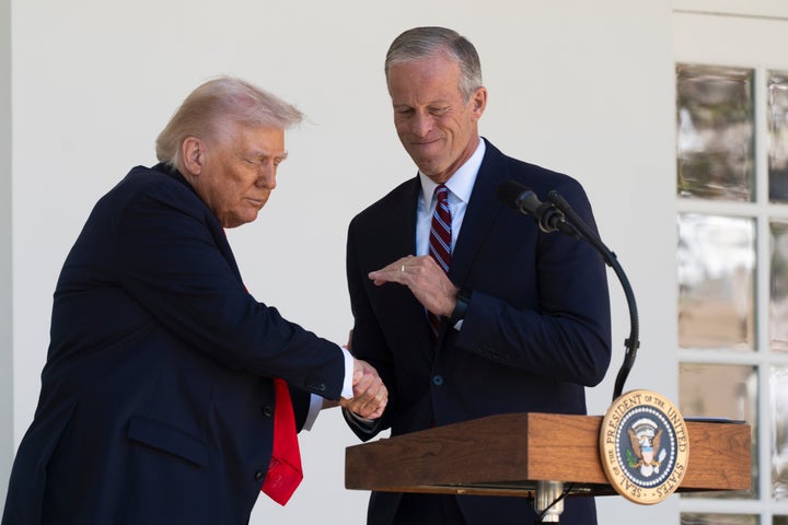 President Donald Trump shakes hands with Senate Majority Leader John Thune (R-S.D.) during a lunch with Republican senators on the Rose Garden patio on Oct. 21, 2025.