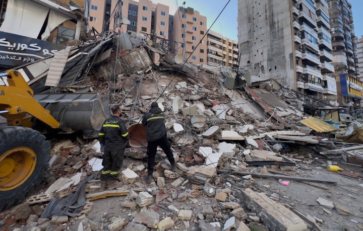Civil defense workers check a destroyed building that was hit by an Israeli airstrike in Dahiyeh, Beirut's southern suburbs, Lebanon, on March 24, 2026.