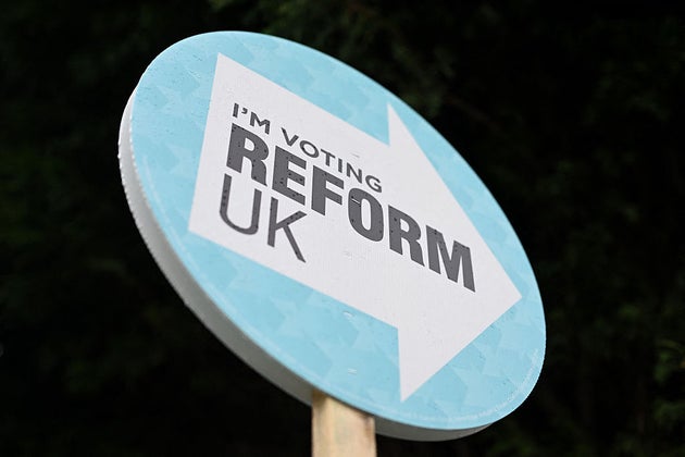 A poster supporting Britain's Reform UK party is pictured outside of a residential property in Denton, Greater Manchester on February 12, 2026, as parties begin to canvas voters ahead of the crucial Gorton and Denton by-election. The Gorton and Denton by-election on February 26 for one of Labour's parliamentary seats will be fiercely contested. (Photo by Oli SCARFF / AFP via Getty Images)