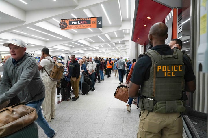 ICE agents look on as travelers stand in long lines at Atlanta Hartsfield-Jackson International Airport on March 23, 2026 in Atlanta, Georgia.
