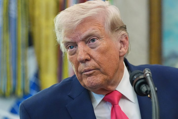 President Donald Trump listens to a reporter during the swearing-in of Secretary of Homeland Security Markwayne Mullin in the Oval Office of the White House, March 24, 2026, in Washington.
