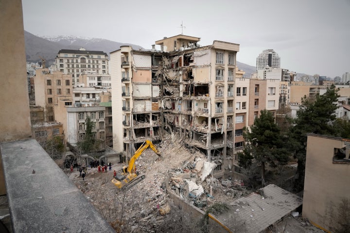 Iranian Red Crescent emergency workers use a bulldozer to clear rubble from a residential building that was hit in an earlier U.S.-Israeli strike in Tehran, Iran, on March 23.