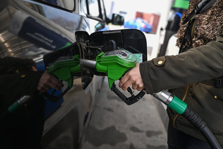 Nearly half of Americans polled also said they are “extremely” or “very” concerned about being able to afford gas in the next few months. A woman fills a car with gasoline.