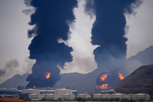 Plumes of smoke and fire rise after debris from an intercepted Iranian drone struck an oil facility in the United Arab Emirates.