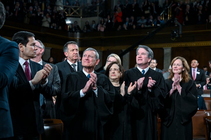 Justice Amy Coney Barrett, right, was among the justices to applaud before Donald Trump's State of the Union speech in February.