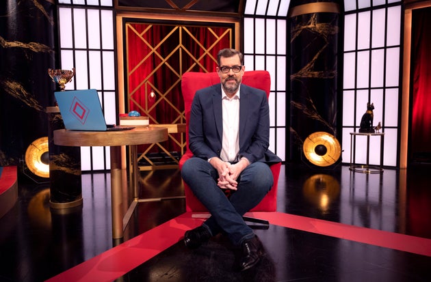 Richard Osman in his iconic House Of Games big red chair