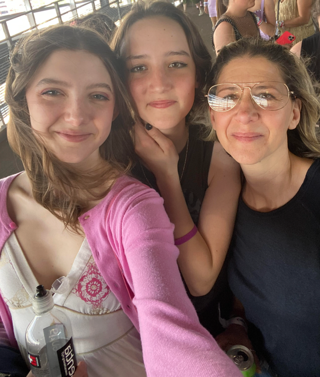 The author (right) with her daughters at a Taylor Swift concert in 2023