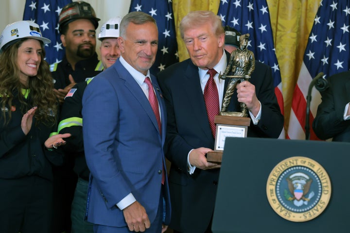 Peabody Energy president and CEO Jim Grech presents Trump with his coal miner statue.