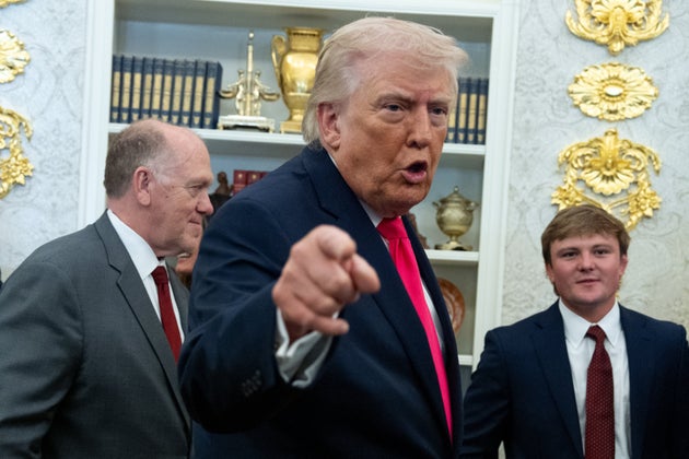 President Donald Trump speaks with reporters during the swearing in ceremony for Homeland Security Secretary Markwayne Mullin in the Oval Office of the White House, Tuesday, March 24, 2026, in Washington.