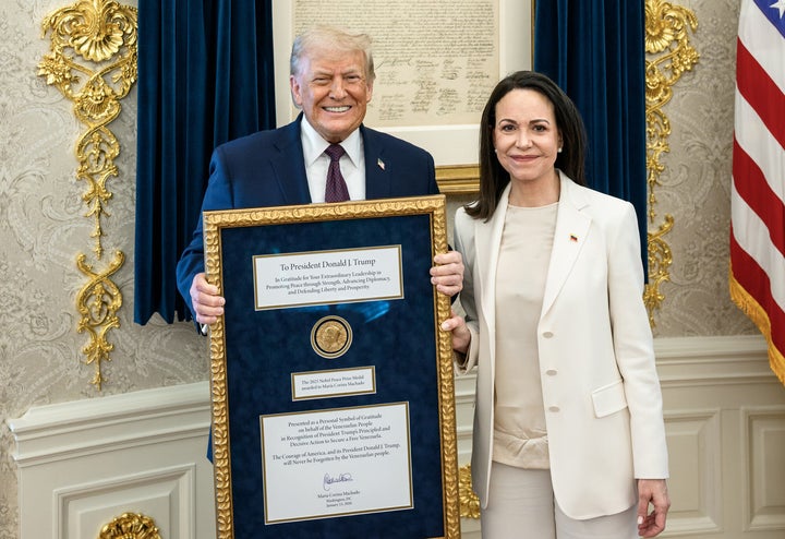 Trump holds Machado's framed Nobel Peace Prize in January.
