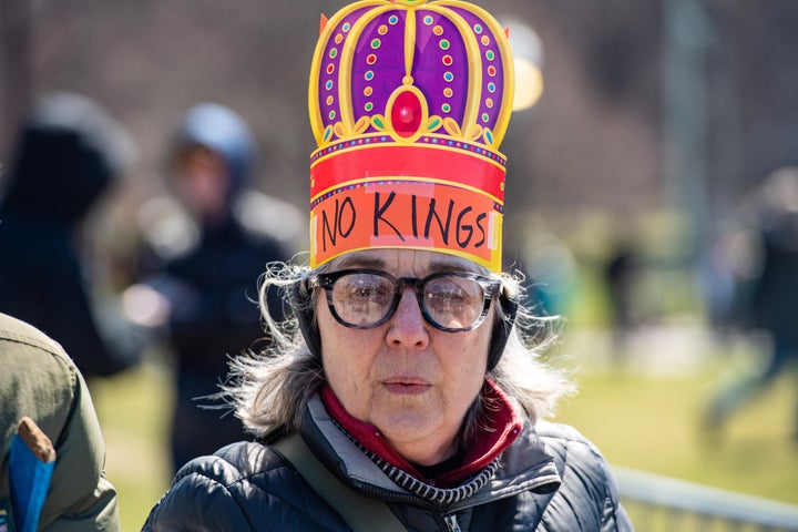 A protester wearing a paper crown arrives for the "No Kings" national day of protest in Boston, Massachusetts.