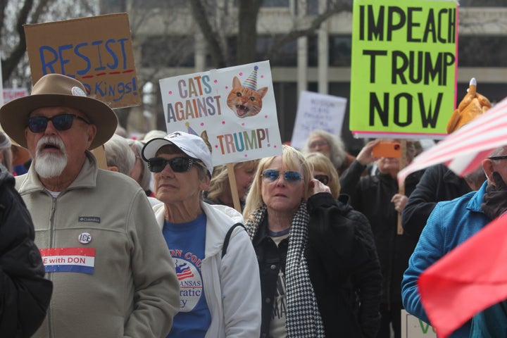 Wendy Wyatt, of Lawrence, Kansas, holds her "Cats Against Trump" sign during a "No Kings" protest at the Kansas Statehouse in Topeka, Kansas