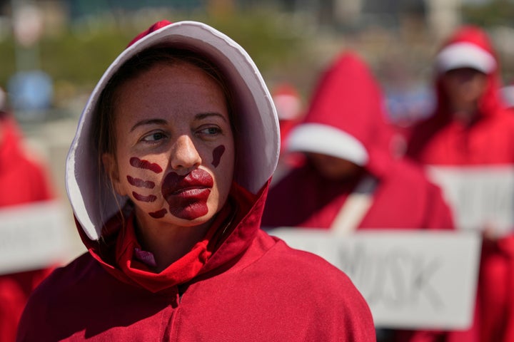 Sara R., dressed as a character from the TV series, "The Handmaid's Tale," demonstrates during a "No Kings" protest in Nashville, Tennessee.