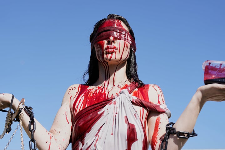 A demonstrator covered in fake blood participates in the "No Kings" protest in Washington, D.C.