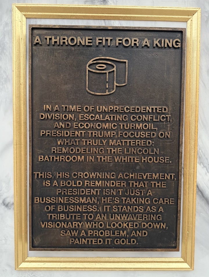 “This, his crowning achievement, is a bold reminder that the President isn’t just a businessman, he’s taking care of business,” reads the toilet monument to Trump.