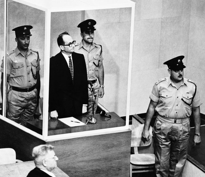 Nazi war criminal Adolf Eichmann is flanked by guards as he stands in his prisoner's dock, while Israel's Supreme Court justices enter the courtroom in Jerusalem, on May 29, 1962. Israel's parliament passed a widely condemned law on March 30, 2026, to make hanging the default punishment for Palestinian prisoners. Eichmann's case was the last time Israel put anyone to death.