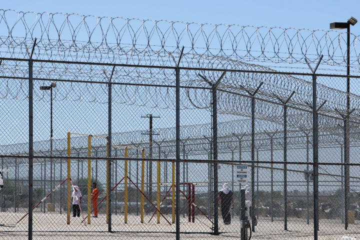 People detained are seen behind fences at the Desert View Annex at the private prison company GEO Group Adelanto ICE Processing Center detention facility, which has faced scrutiny for its conditions.