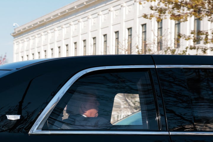 President Donald Trump rides in his motorcade as he arrives at the US Supreme Court in Washington, D.C., on April 1.