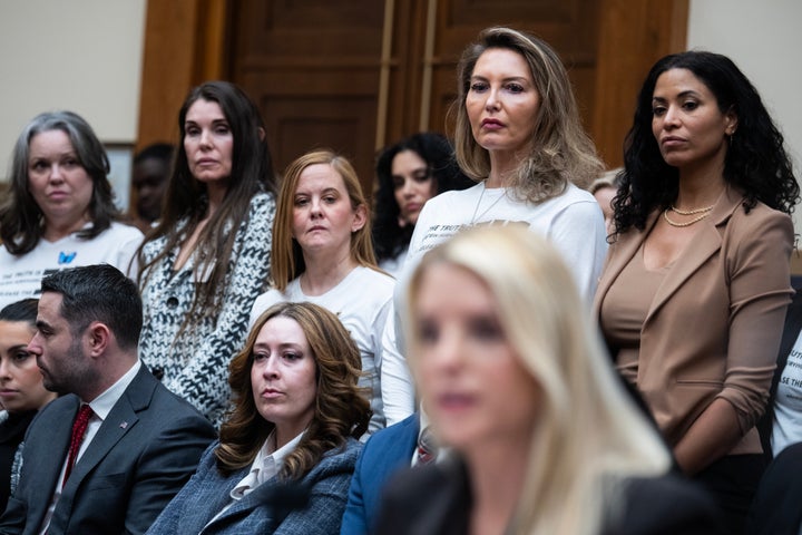 Attorney General Pam Bondi testifies as survivors of Jeffrey Epstein's child sex abuse stand in the background, during the House Judiciary Committee hearing on the Justice Department's handling of the Epstein files, on Feb. 11.